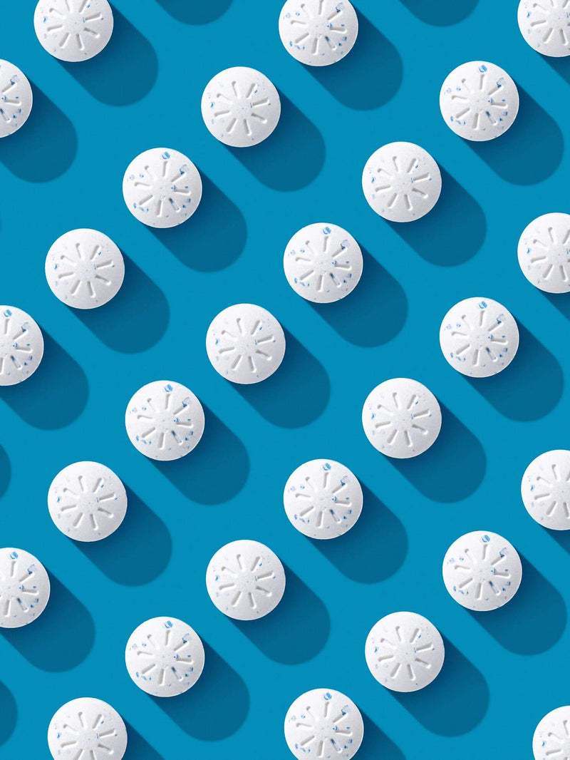 Multiple Neuro Energy Gum pieces arranged on a blue background