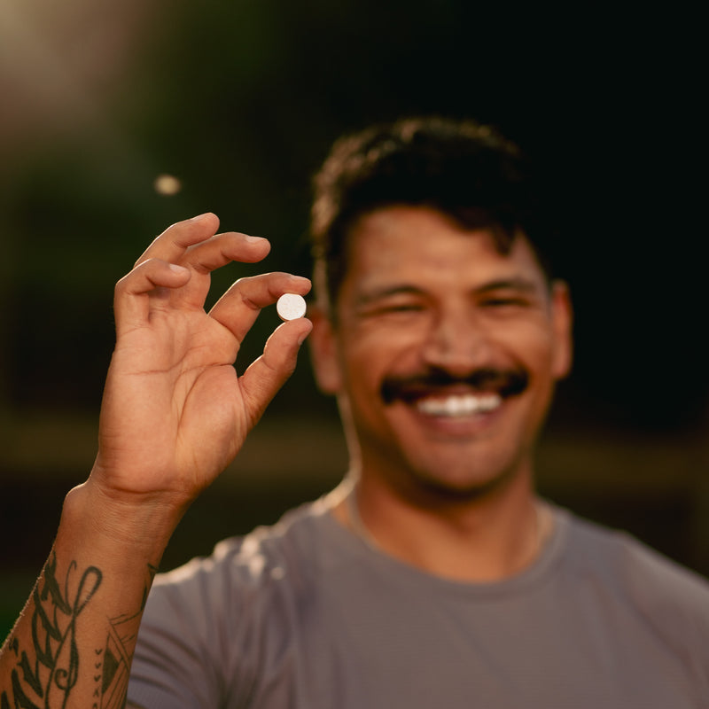 Man holding a single Neuro Energy Gum piece between his fingers