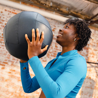 Woman holding a medicine ball during a workout